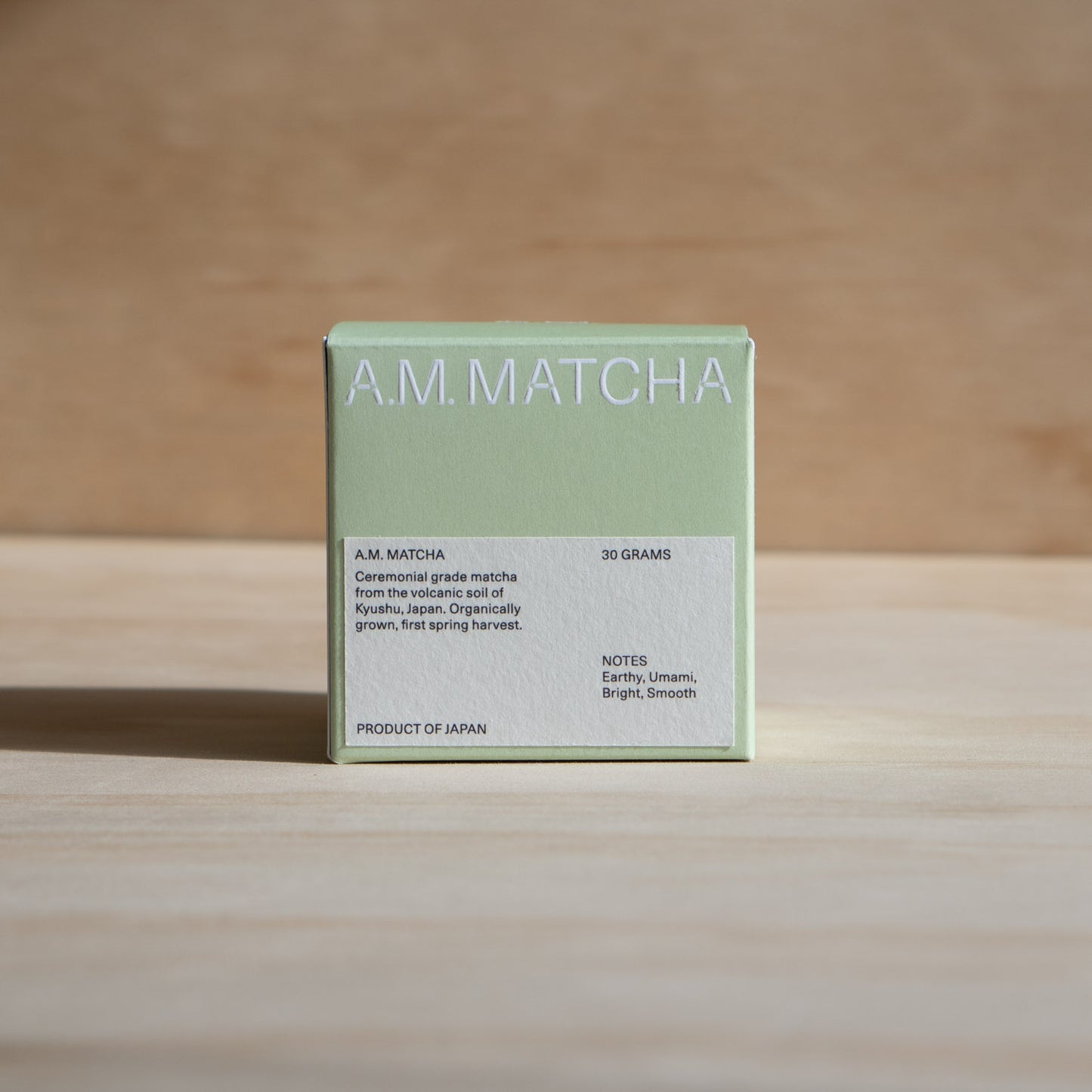 A.M. Matcha packaging on a wooden surface