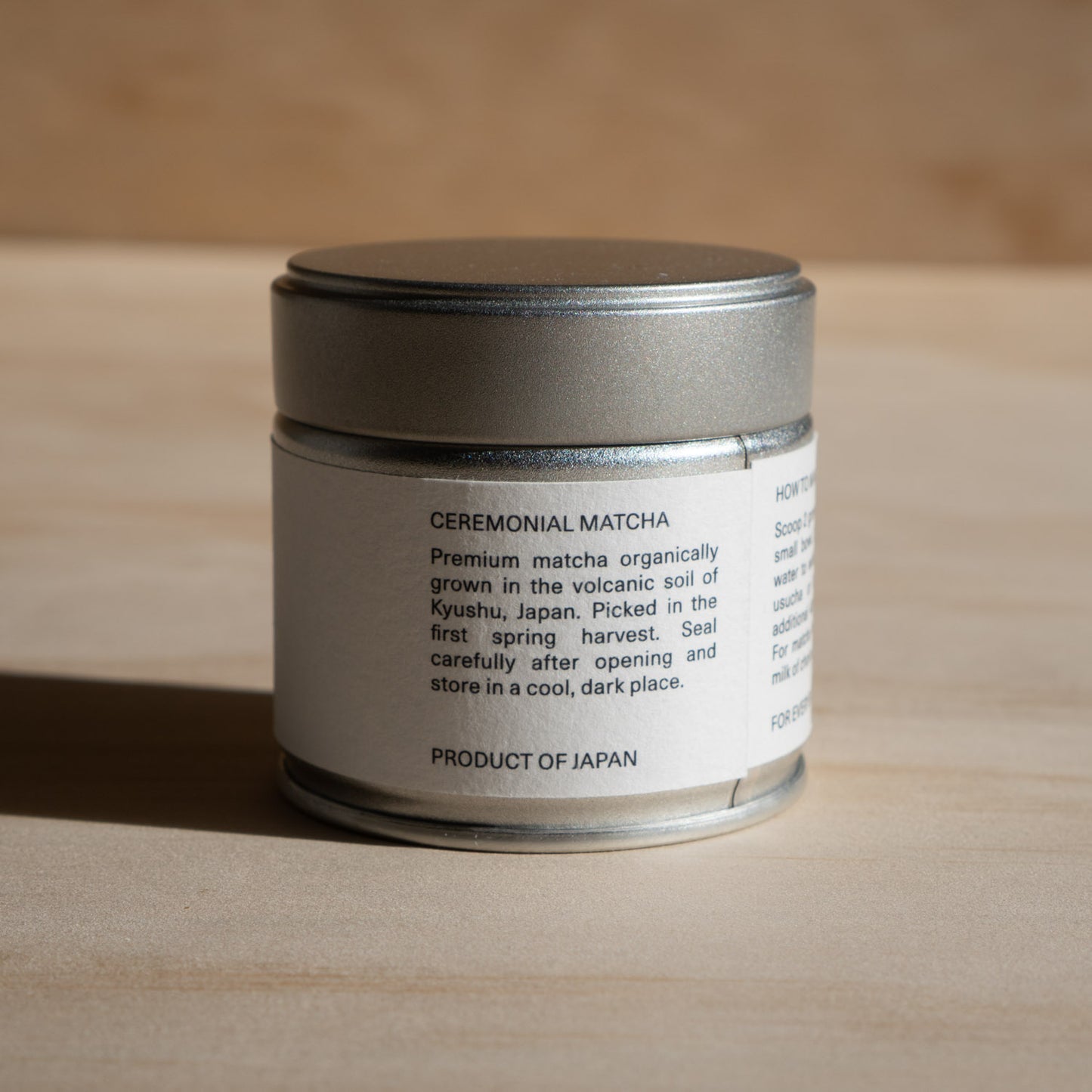 Ceremonial matcha container with label on a wooden surface