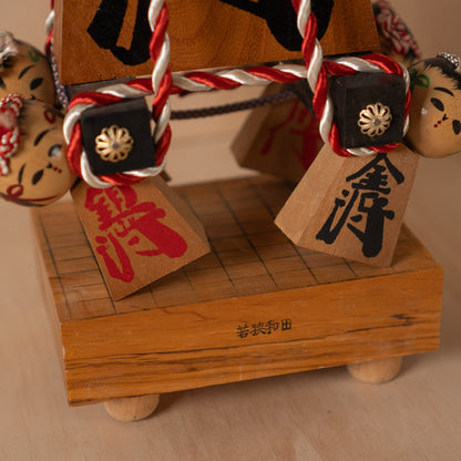 Vintage Japanese Folk Art Sculpture - Kokeshi holding giant Shogi Chess piece