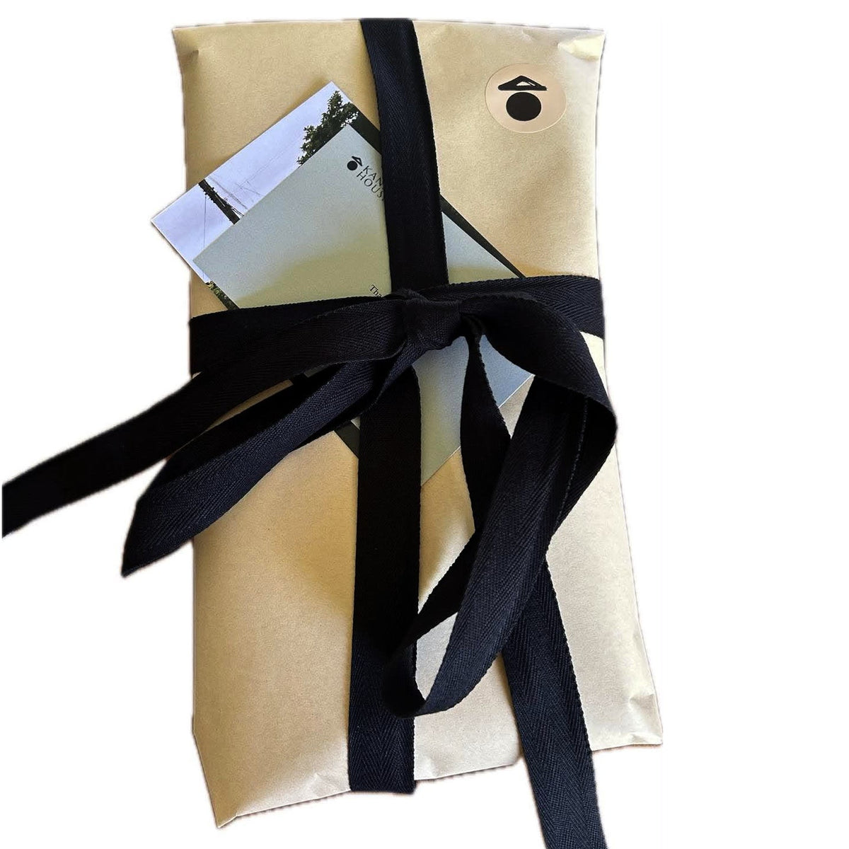 Gift wrapping with brown paper and black cotton ribbon